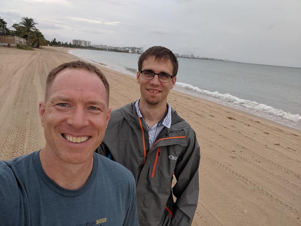 Mark and Kevin take a selfie on the beach.